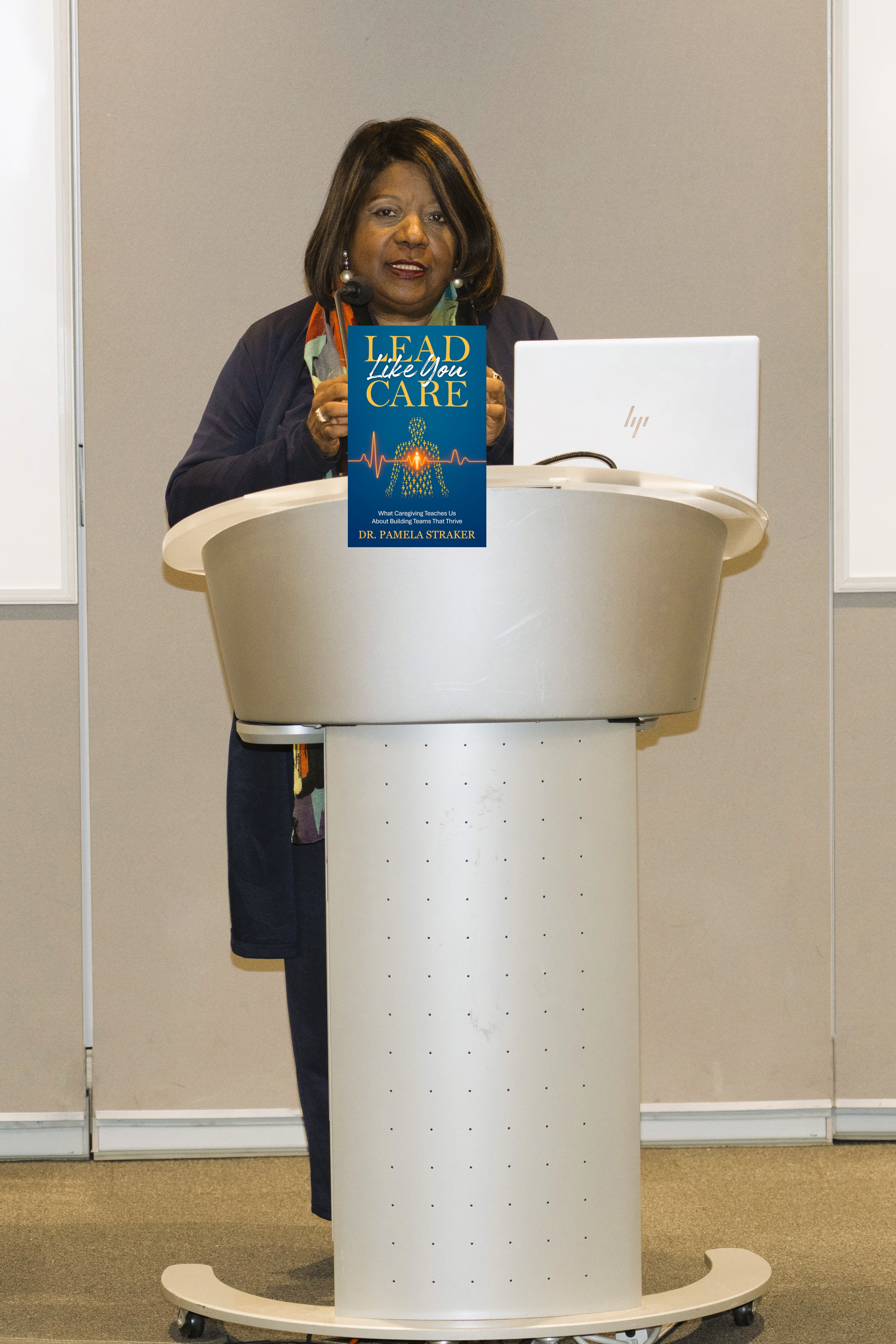 Dr. Pam speaking at podium